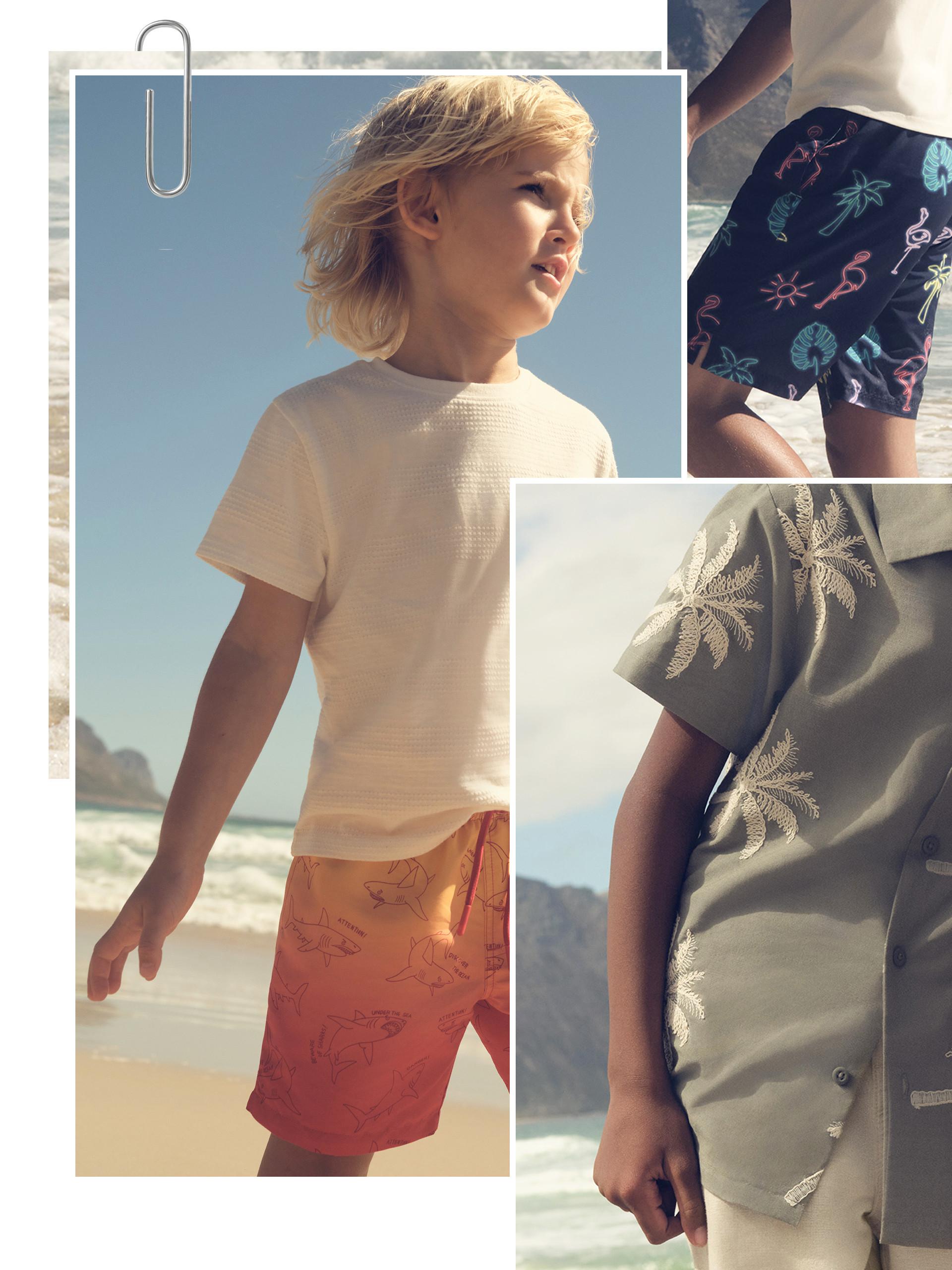 Kid wearing orange ombre swim shorts and white t-shirt
