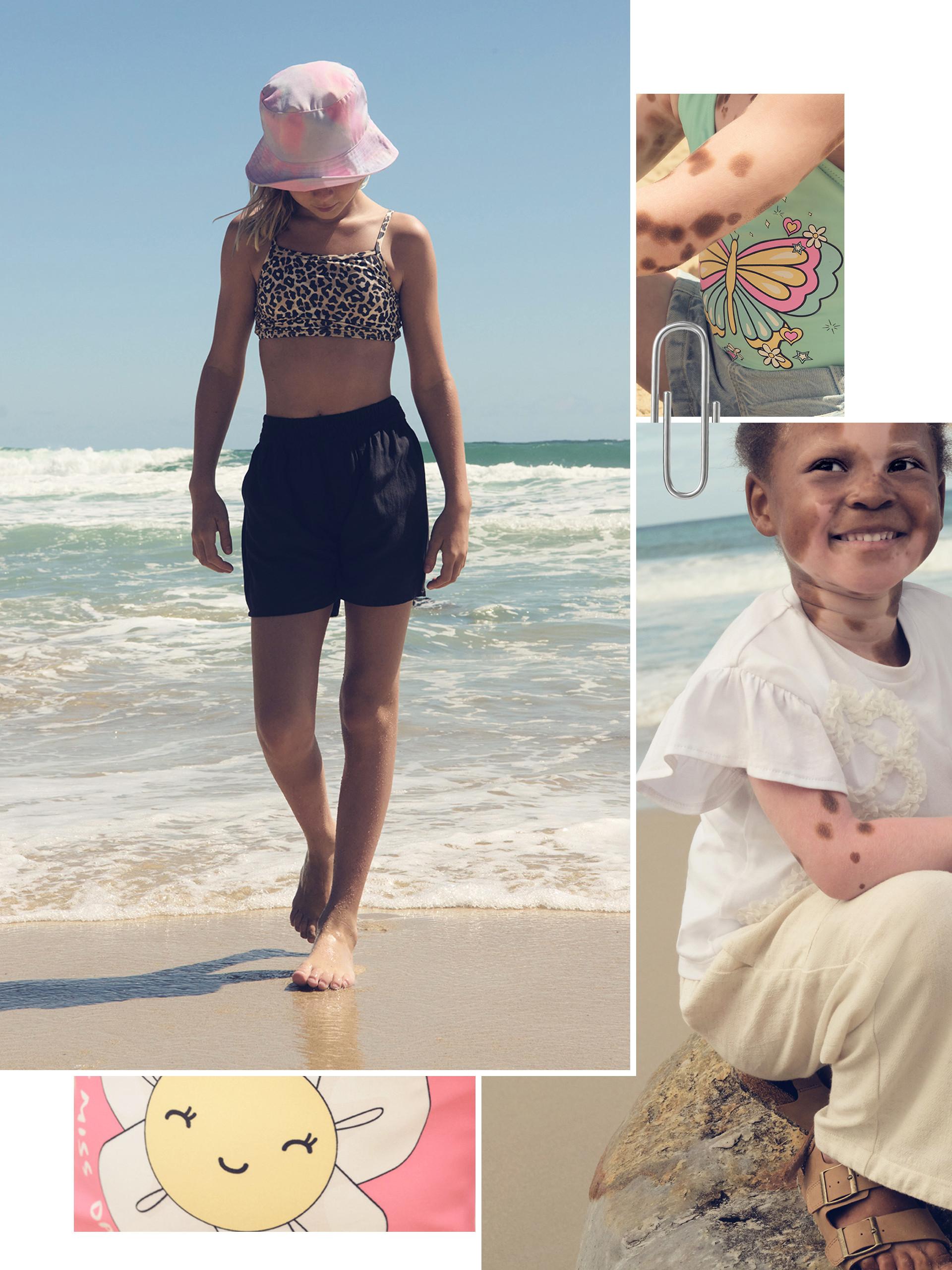 2 kids, one in black shorts, bikini top and pink bucket hat, the other in cream trousers and white t-shirt