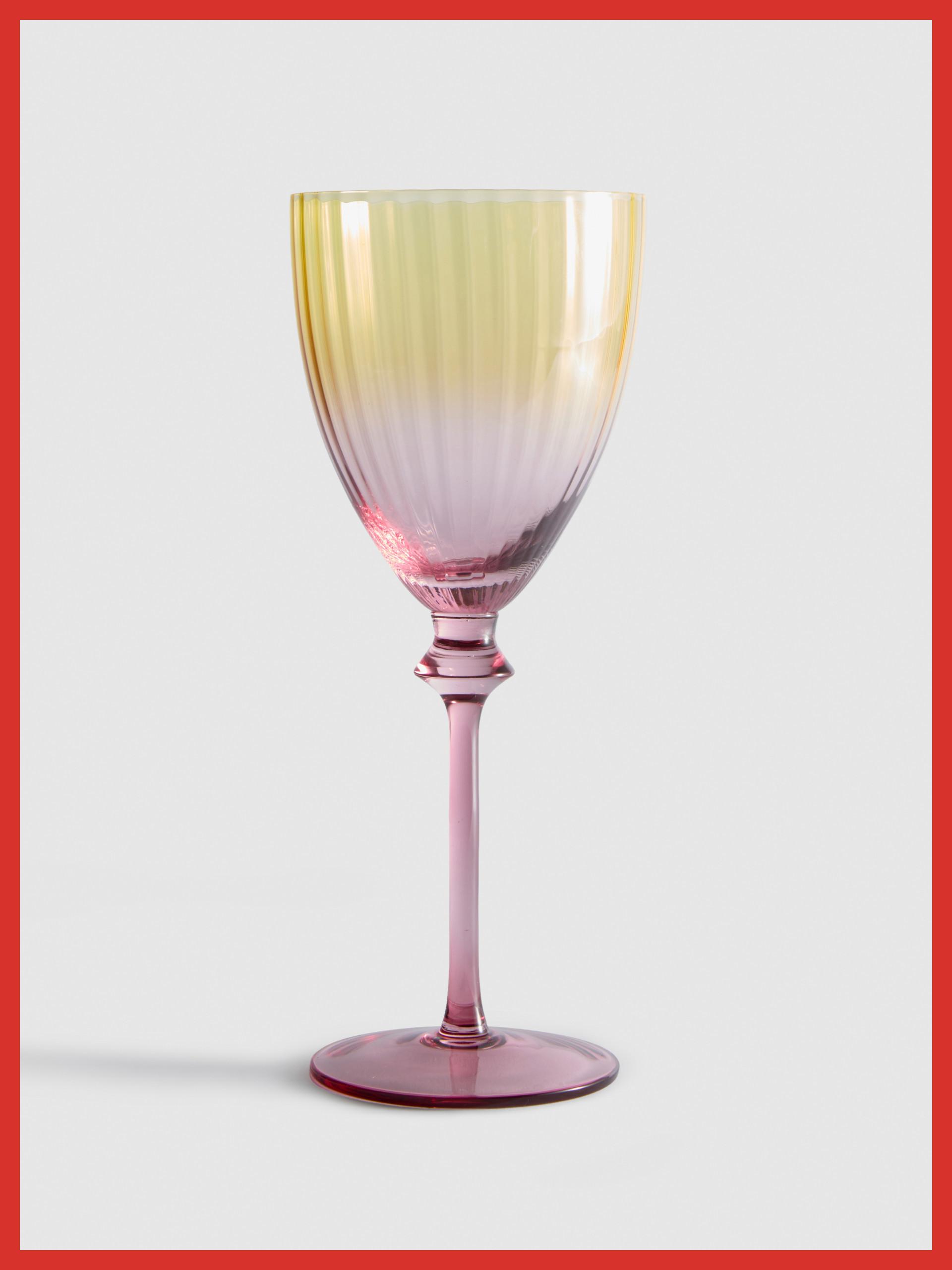 Ribbed wine glass with ombré effect transitioning from yellow through pink to purple on stem and base.