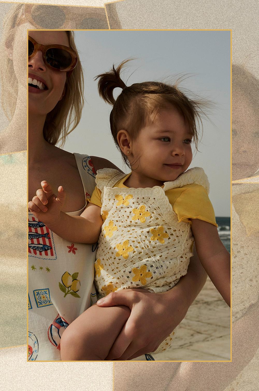 Family of five walking together on beach wearing colourful striped swimwear and summer clothing.