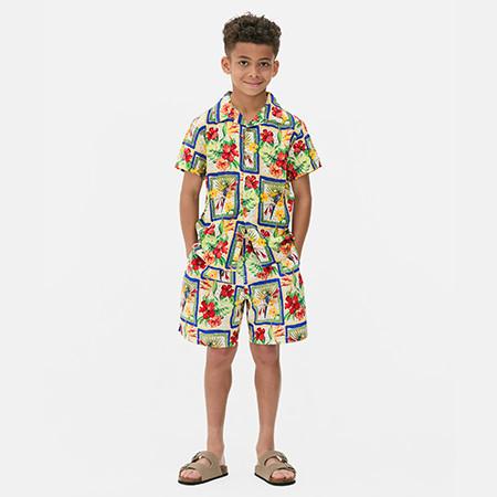 Kid wearing tropical print shirt and matching shorts