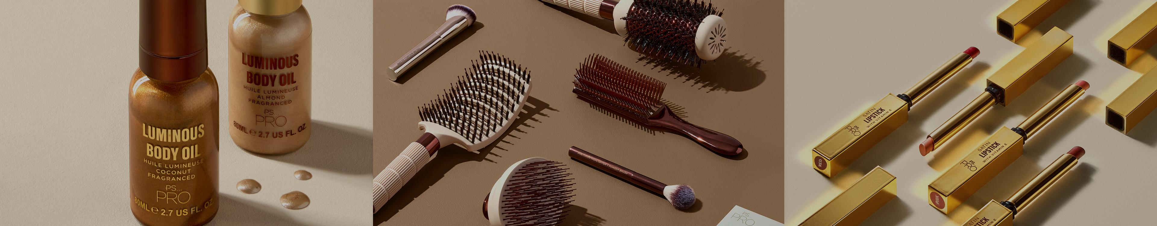 Collection of beauty products including Luminous Body Oil bottles, various hair brushes and gold-packaged cosmetics arranged on neutral surfaces.