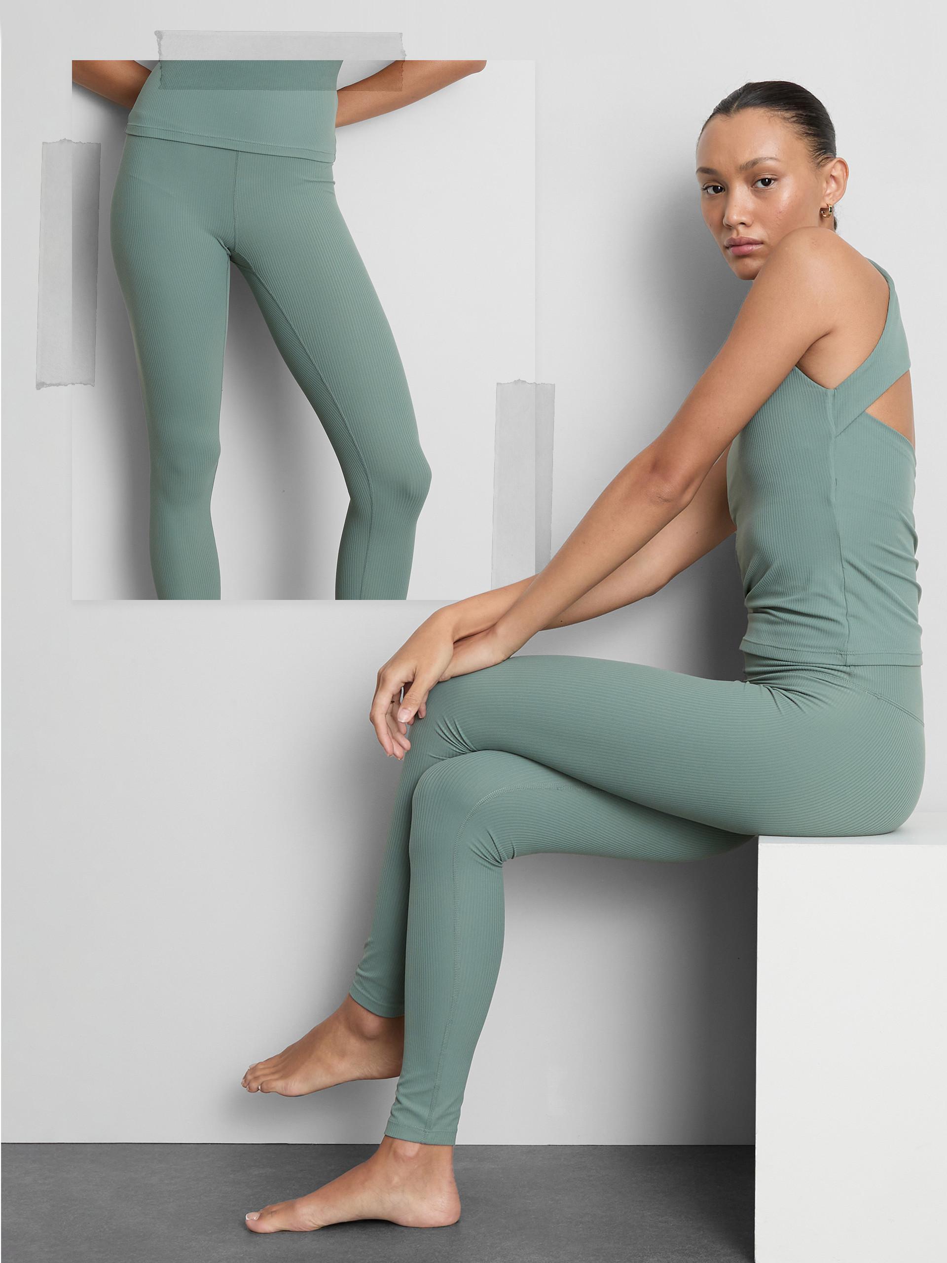 Sage green ribbed activewear set featuring high-waisted leggings and a cross-back tank top.
