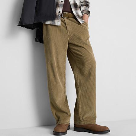 Tan corduroy trousers with wide legs, paired with brown shoes and a plaid shirt.