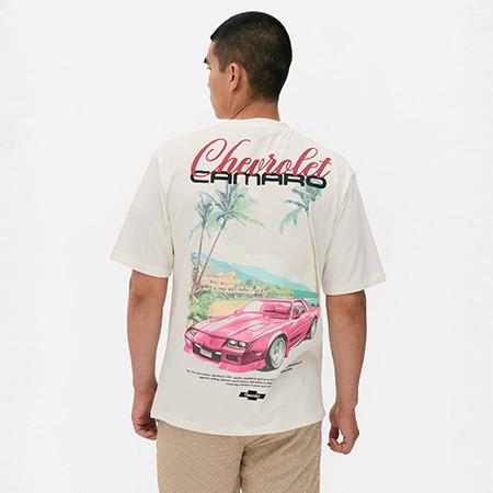 Rear view of person wearing cream T-Shirt with Chevrolet Camaro graphic showing pink car and palm trees.