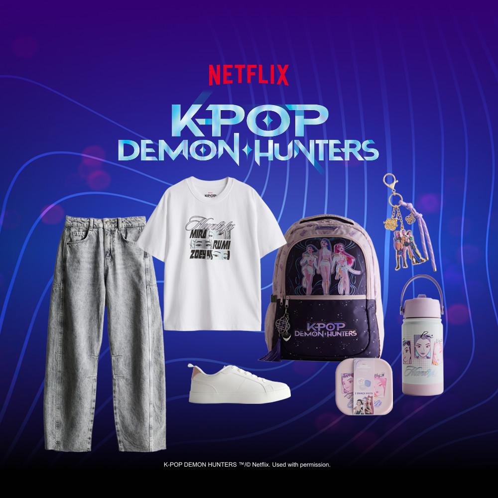 Netflix K-POP DEMON HUNTERS collection including gray jeans, white T-shirt, sneakers, backpack, keychain and lunchbox.