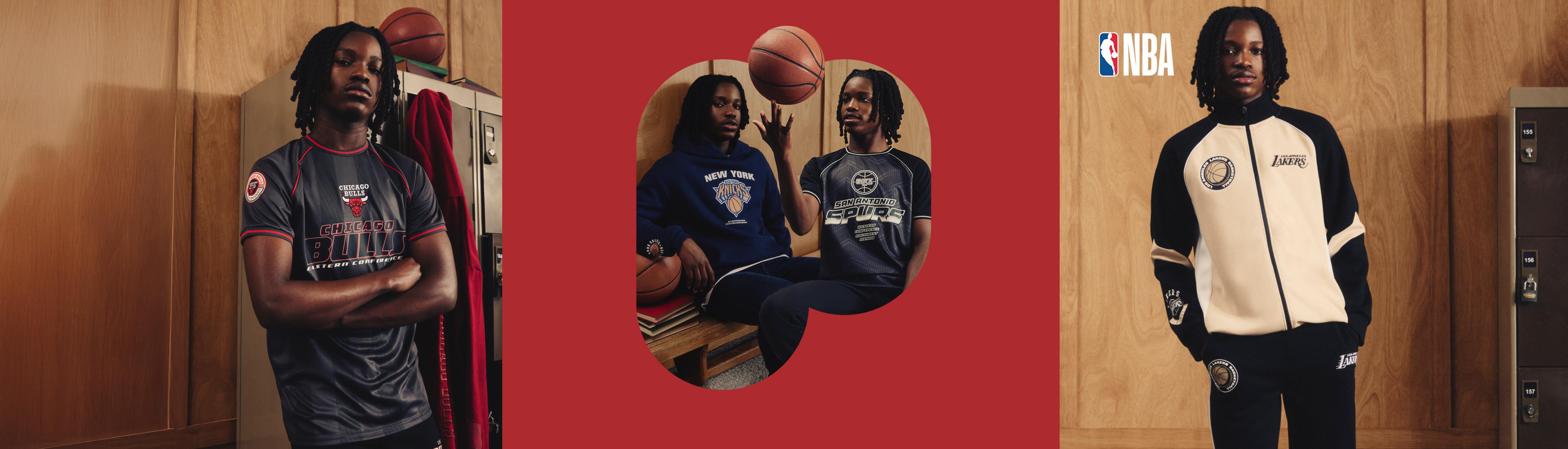 Three NBA apparel items: Chicago Bulls jersey, San Antonio Spurs shirt with basketball, and Lakers track jacket. Official NBA merchandise shown against wooden backdrop.
