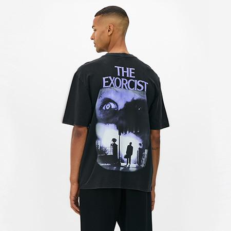 Model wearing black t-shirt with purple "The Exorcist" print