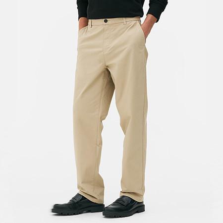 Model wearing cream smart trousers and black shoes