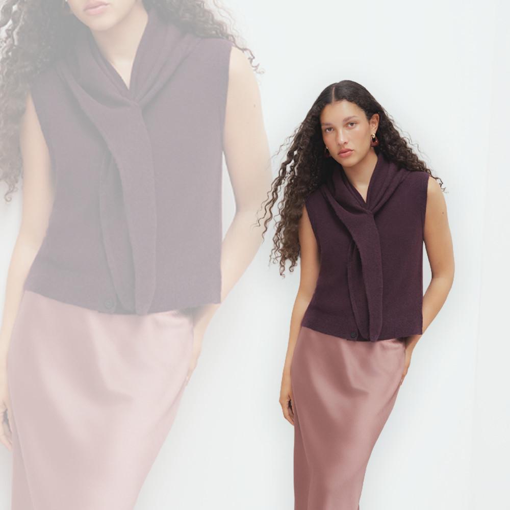Model wearing plum sleeveless top with draped cowl neck and pink pants.
