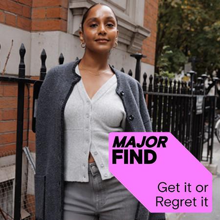 Person wearing grey cardigan and coat on city street with "MAJOR FIND" promotional text overlay.