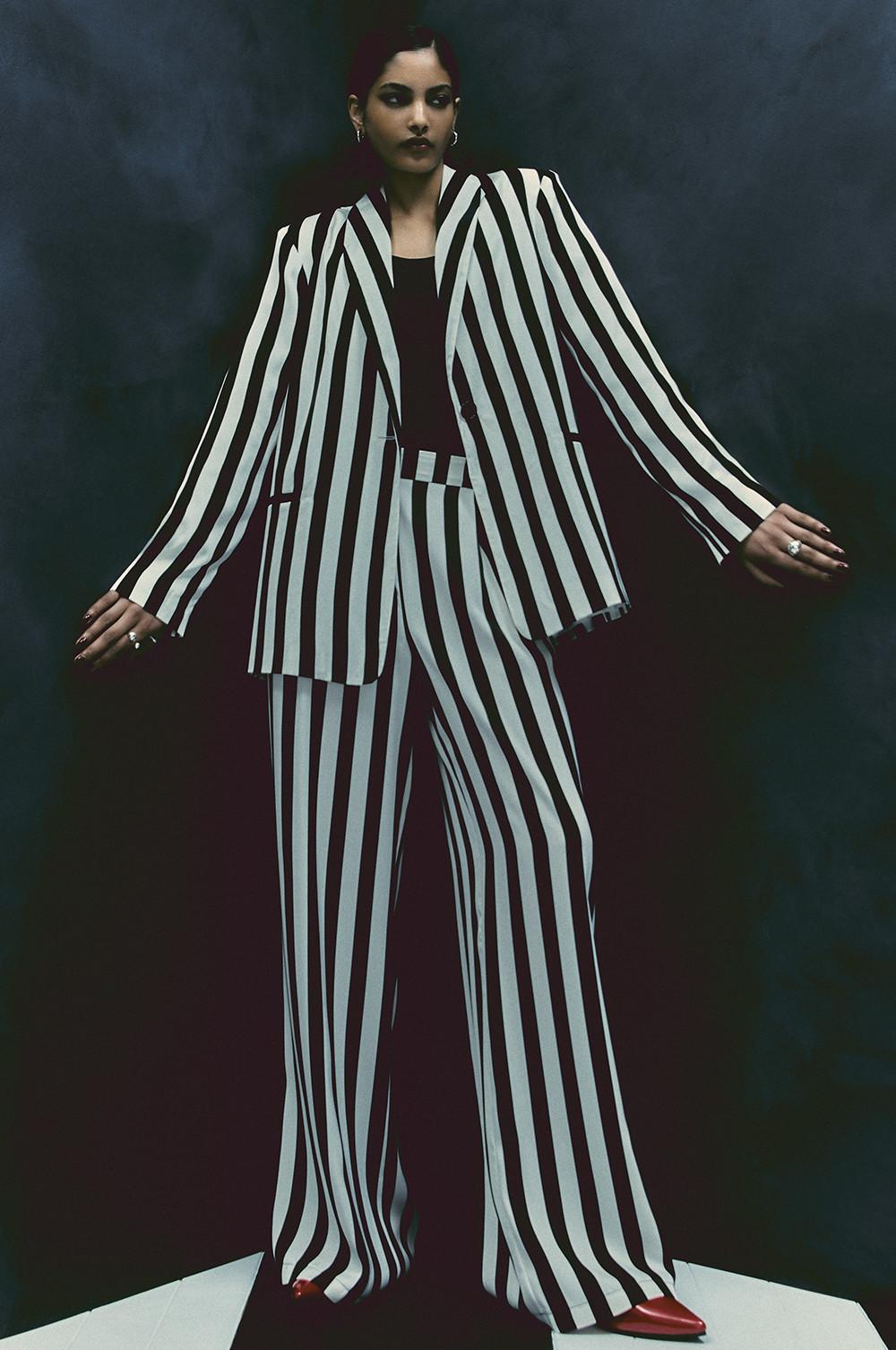 Le mannequin porte un blazer et un pantalon à rayures noires et blanches