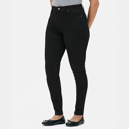 Black wide leg jeans with classic five-pocket styling worn with a cropped top. Person's hand in pocket.