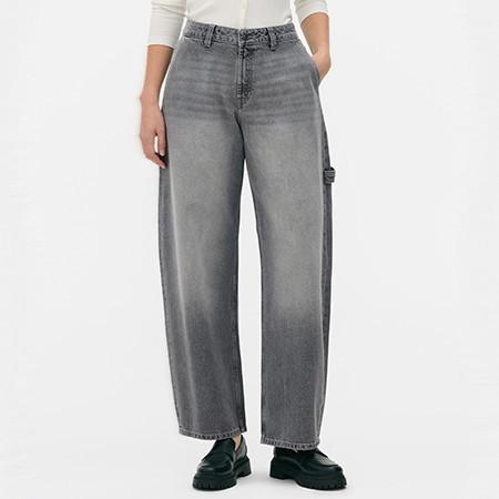 Grey wide leg jeans with utility pocket detail, shown with a white top and black shoes.