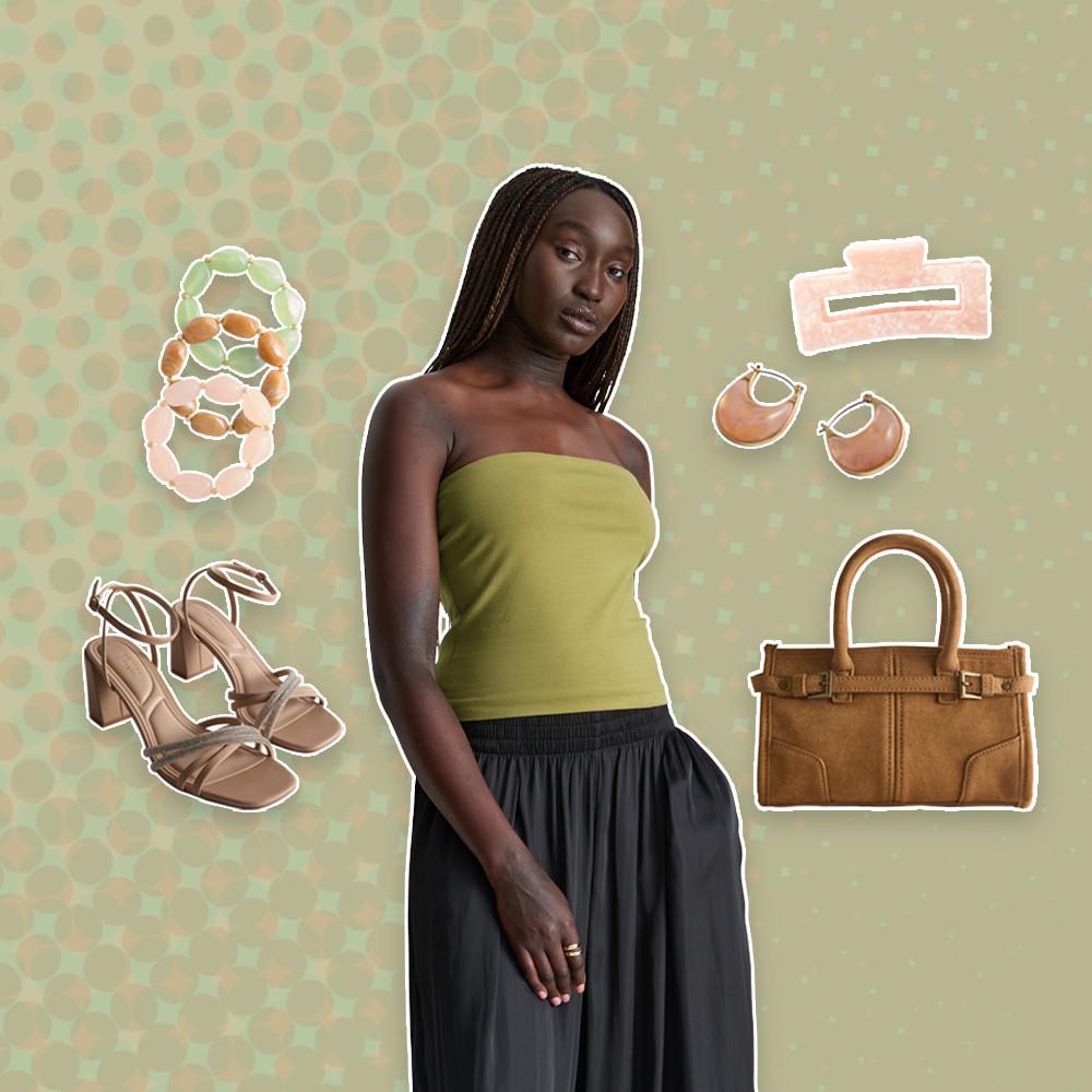 Model modeling olive strapless top and black skirt with fashion accessories including sandals, handbag and jewelry.