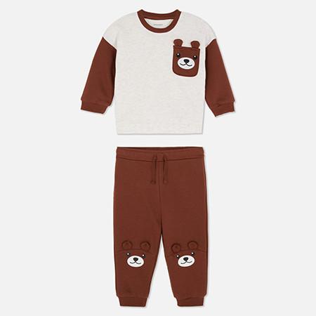 Children's brown and cream outfit with bear pocket detail on sweatshirt and knee patches on joggers.