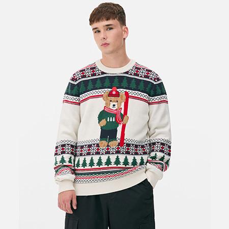 Person wearing festive cream jumper with bear design, fair isle pattern and Christmas trees.