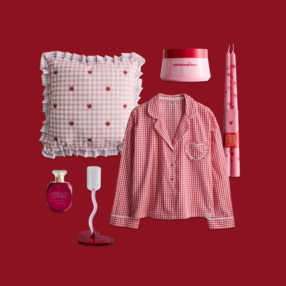 Valentine's themed collection with red gingham pyjama top, strawberry cushion, body butter, candles and perfume.
