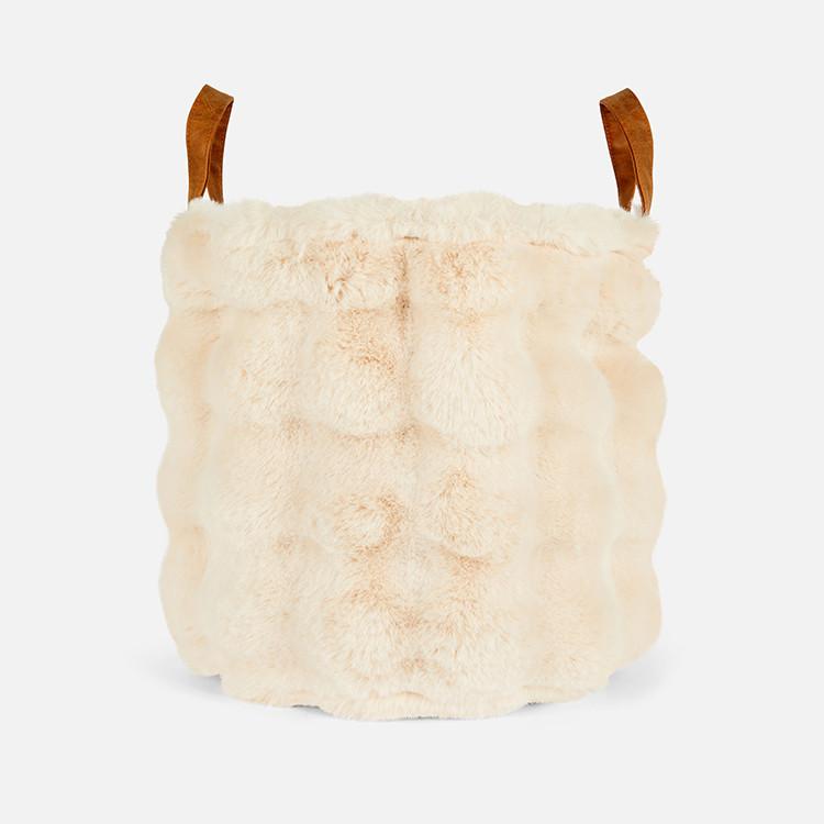 Cream faux fur storage basket with brown leather handles, featuring a soft textured exterior.