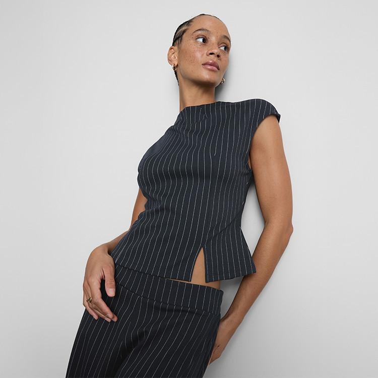 Model wearing pinstripe top and bottoms