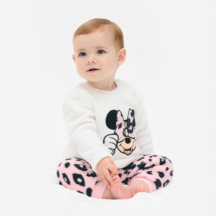 Baby wearing white Minnie Mouse jumper with pink leopard print leggings sitting against white background.