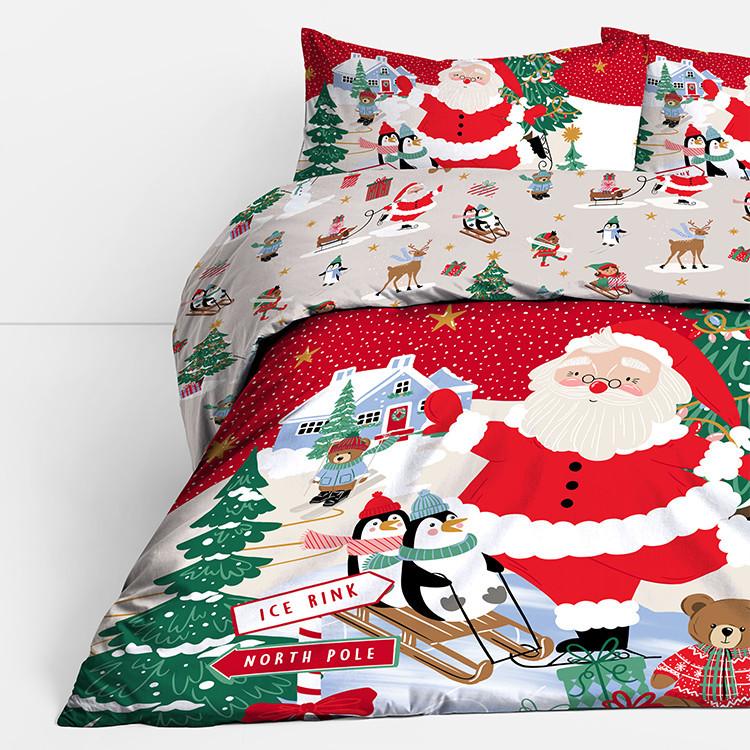 Christmas bedding set with Santa, penguins, reindeer and festive scenes on red and white duvet cover.
