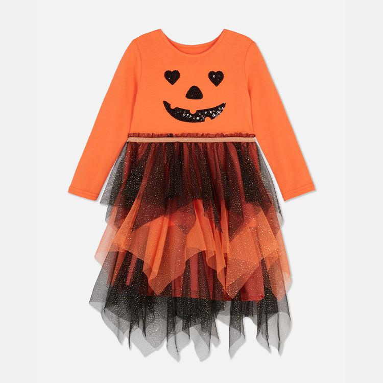 Orange Halloween pumpkin dress with long sleeves, glittery face design and layered tulle skirt in orange and black.