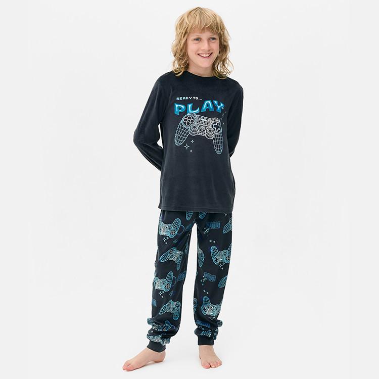 Person wearing navy pyjama set with "READY TO PLAY" text and gaming controller graphic on top and matching bottoms.