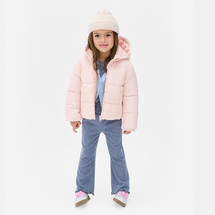Child wearing pink puffer jacket with hood, cream beanie hat, grey tracksuit and pink trainers.