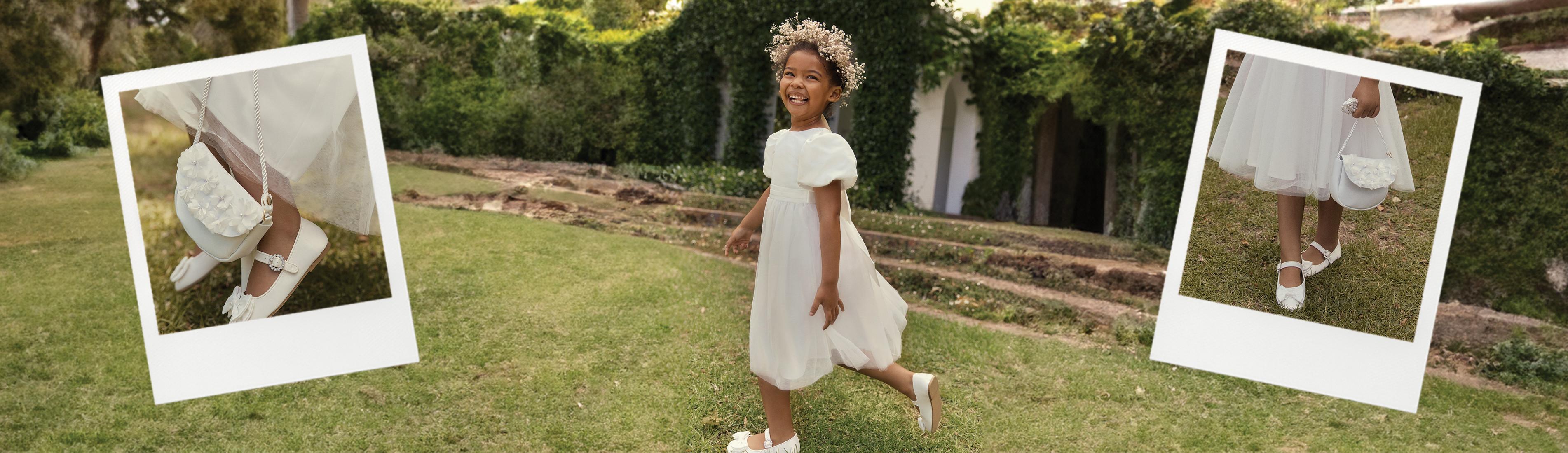 Kind in weißem Kleid und weißen Schuhen