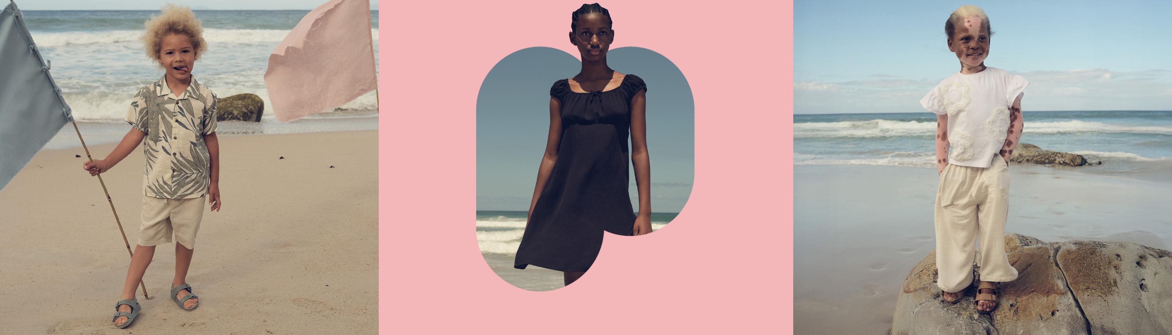 Drie kinderen in zomeroutfits op het strand. Links een shirt met tropische print en een short, in het midden een zwarte jurk en rechts een witte top en lichte broek op rotsen.