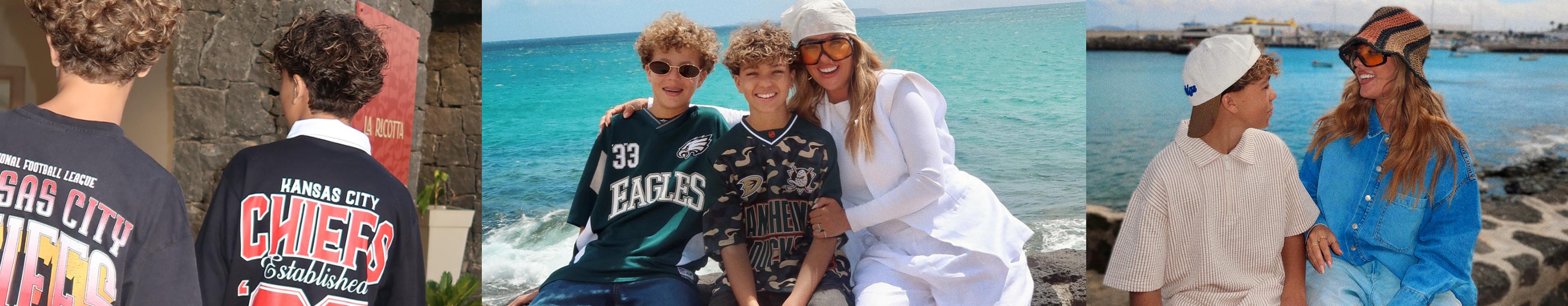 Model and two kids wearing sports team jerseys smiling together at a tropical beach.