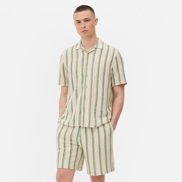 Short-sleeved cream and green striped shirt with matching shorts, creating a coordinated summer set.