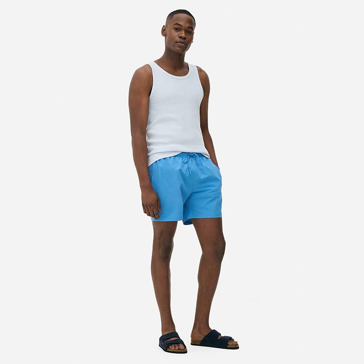 Model wearing vest and shorts