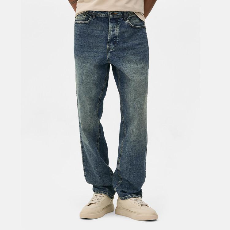 Medium wash straight-leg jeans worn with beige sneakers, showing a relaxed fit style.