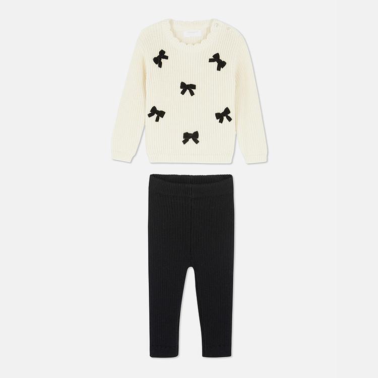 White long sleeve top with bow print and black leggings