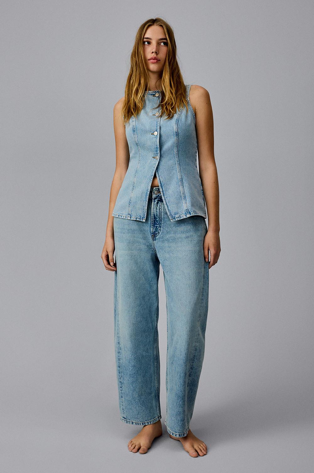 Model wearing blue denim top with blue jeans