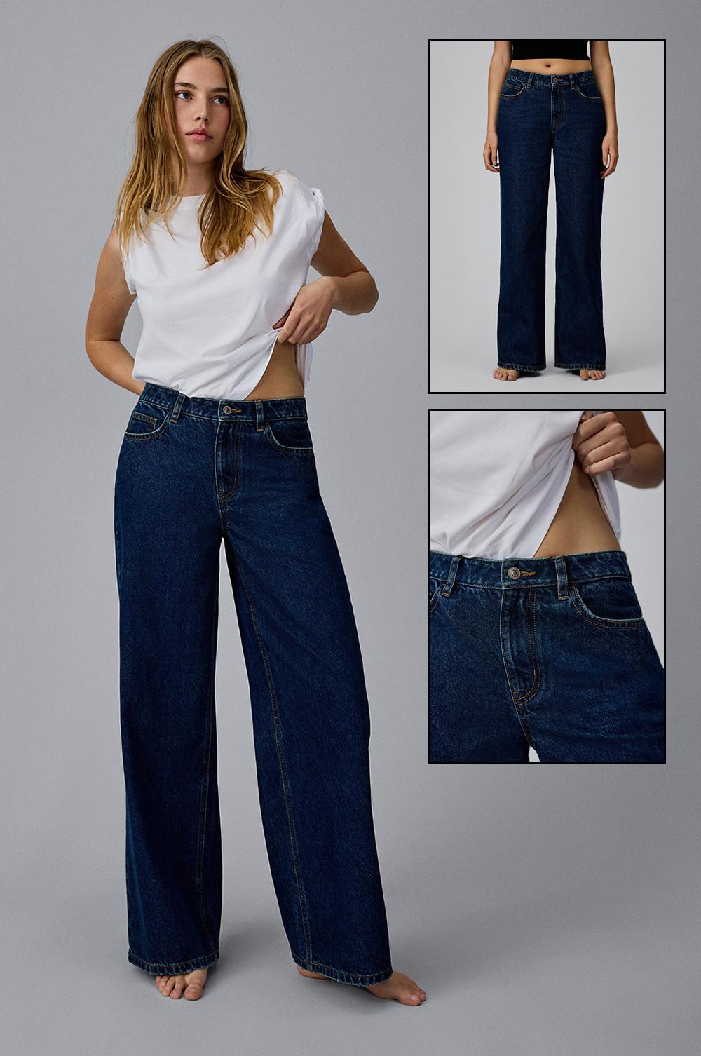 Model wearing wide leg jeans in dark blue with a white t-shirt