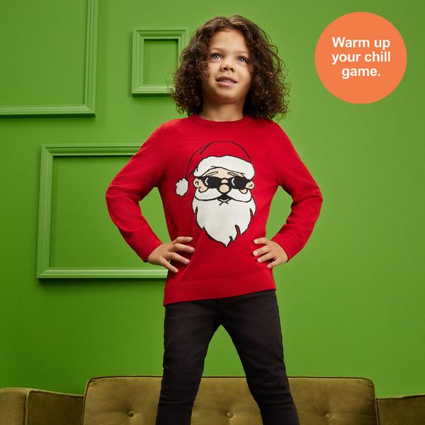 Child wears Father Christmas Red jumper