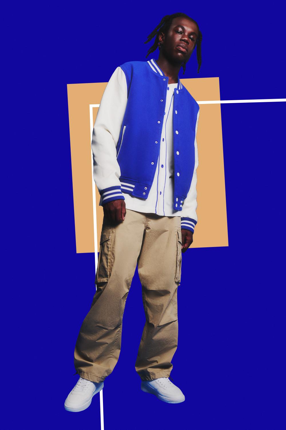 Model in cargos, blue varsity jacket