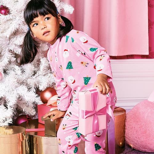 Girl wears pink christmas pyjamas