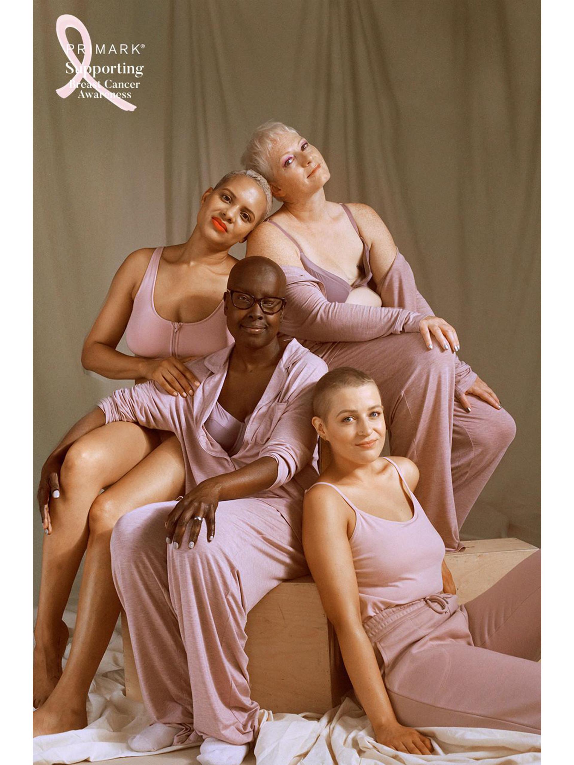 Models sat leaning on one another, smiling