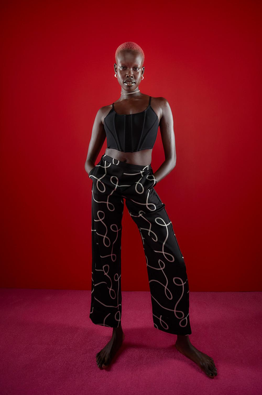 model wears black corset top and white and black squiggle print pyjama bottoms