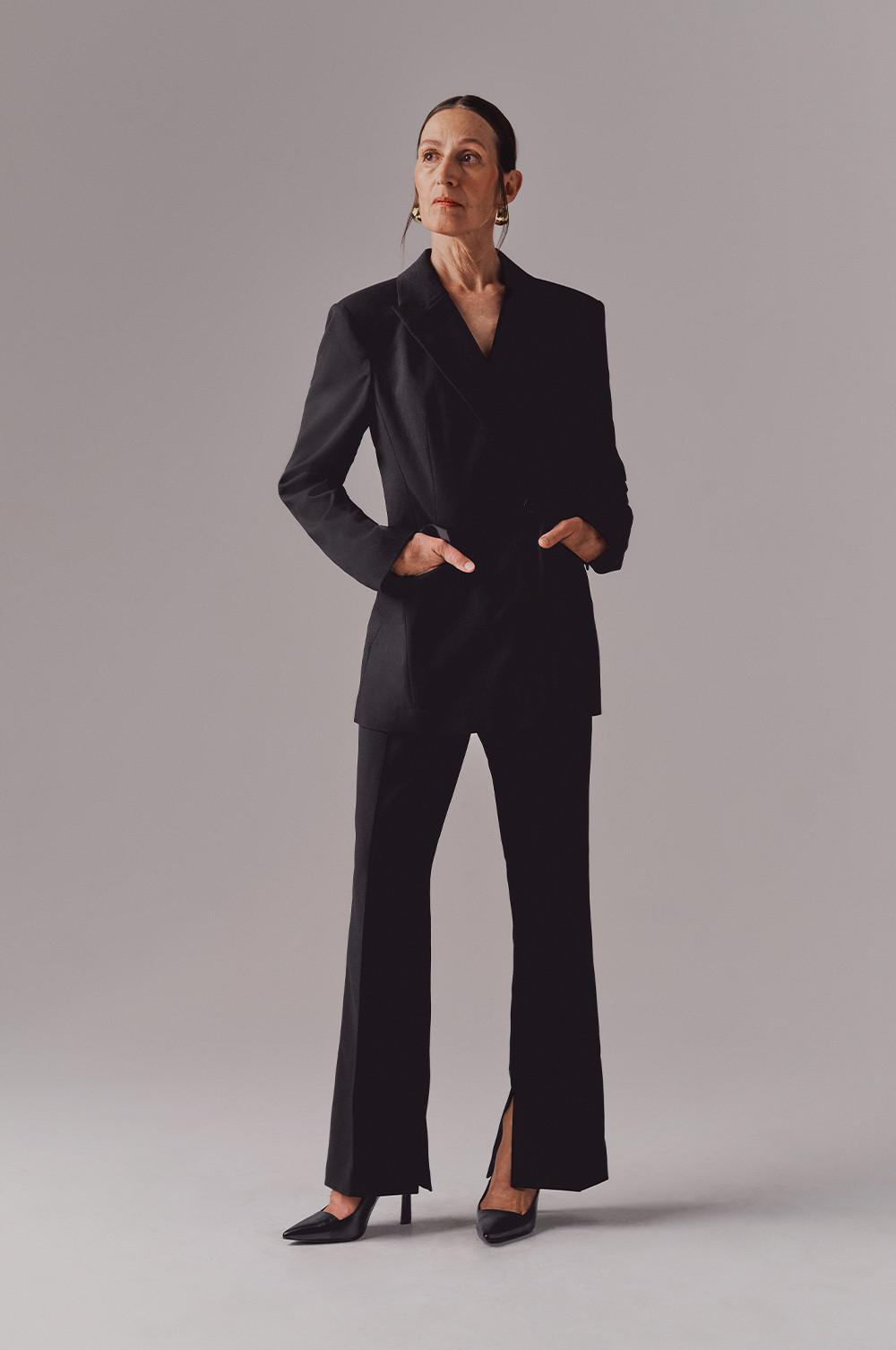 model wears black asymmetric suit