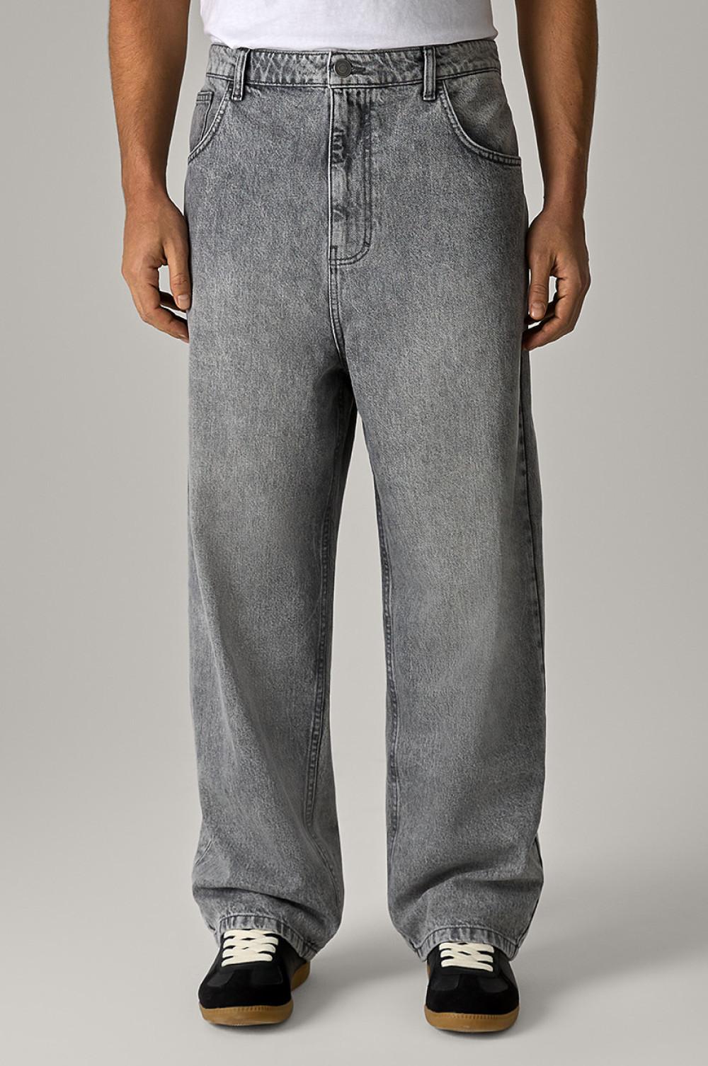 Gray wide-leg jeans with relaxed fit, shown on person wearing white top and black shoes with gum soles.