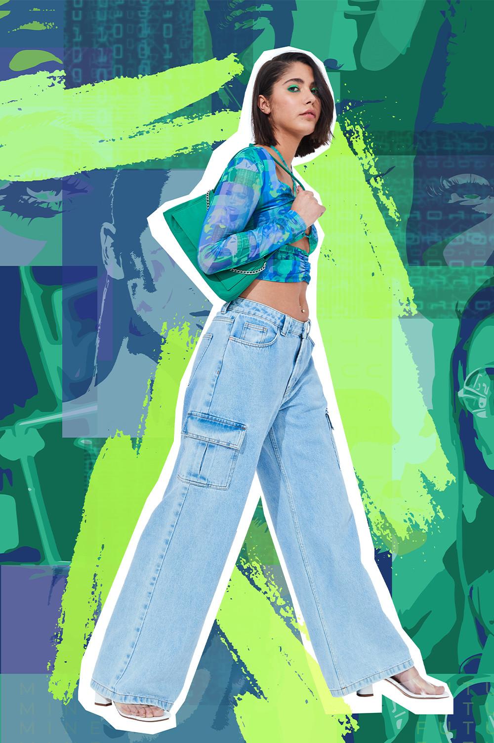 Model wears light blue denim cargo jeans, with cropped patterned top, and white heeled shoes