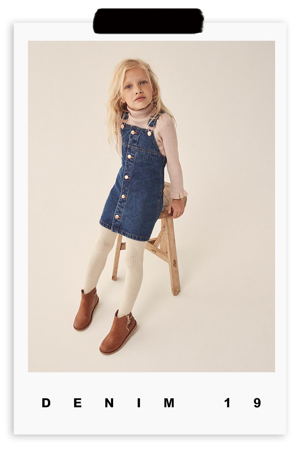 girl in denim pinafore