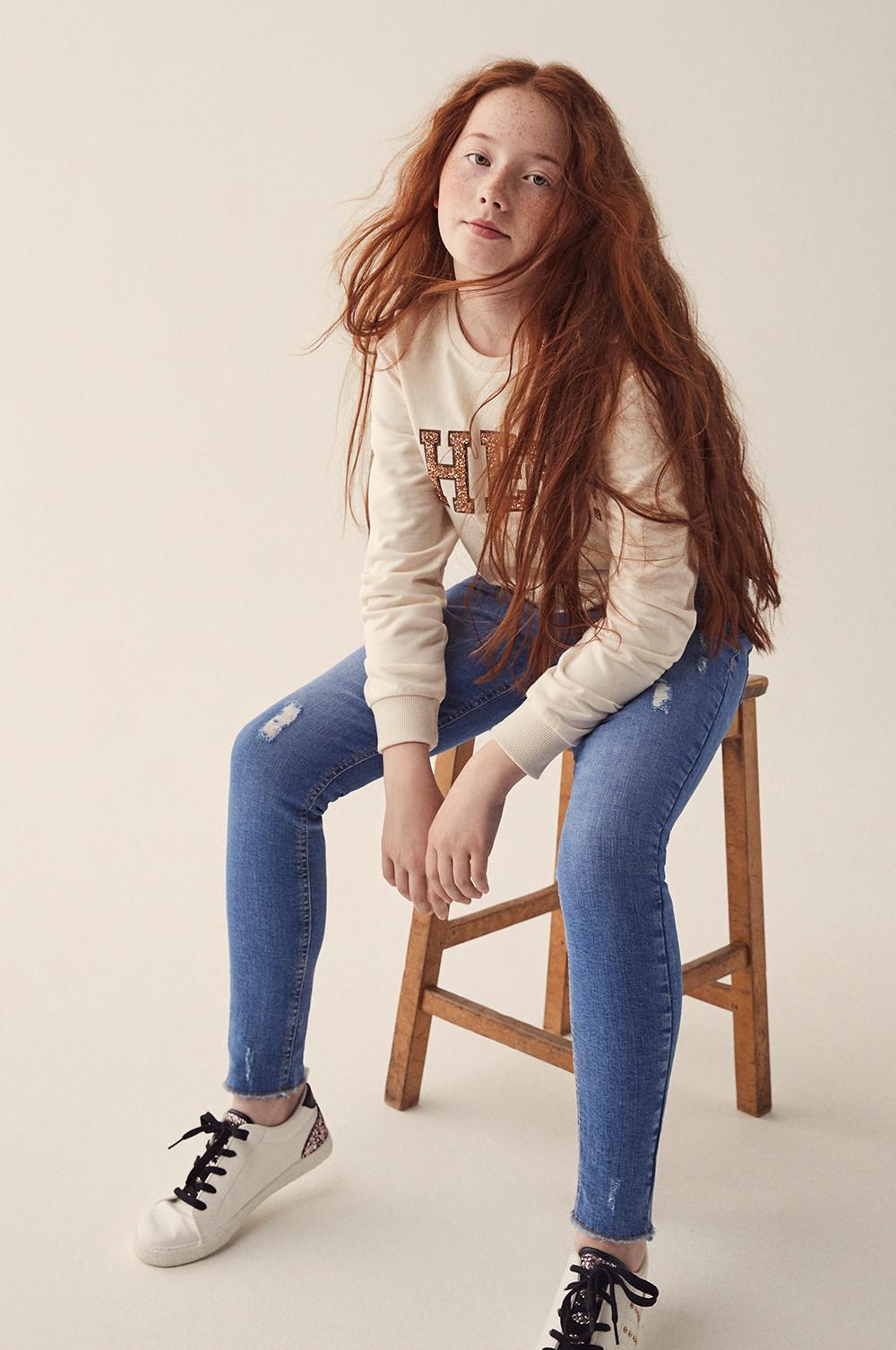girl in jeans and jumper