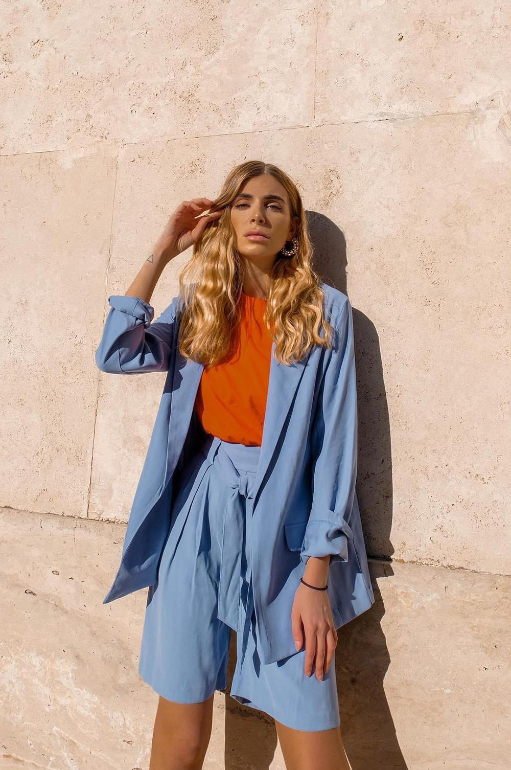 Woman wearing blue tailored shorts suit