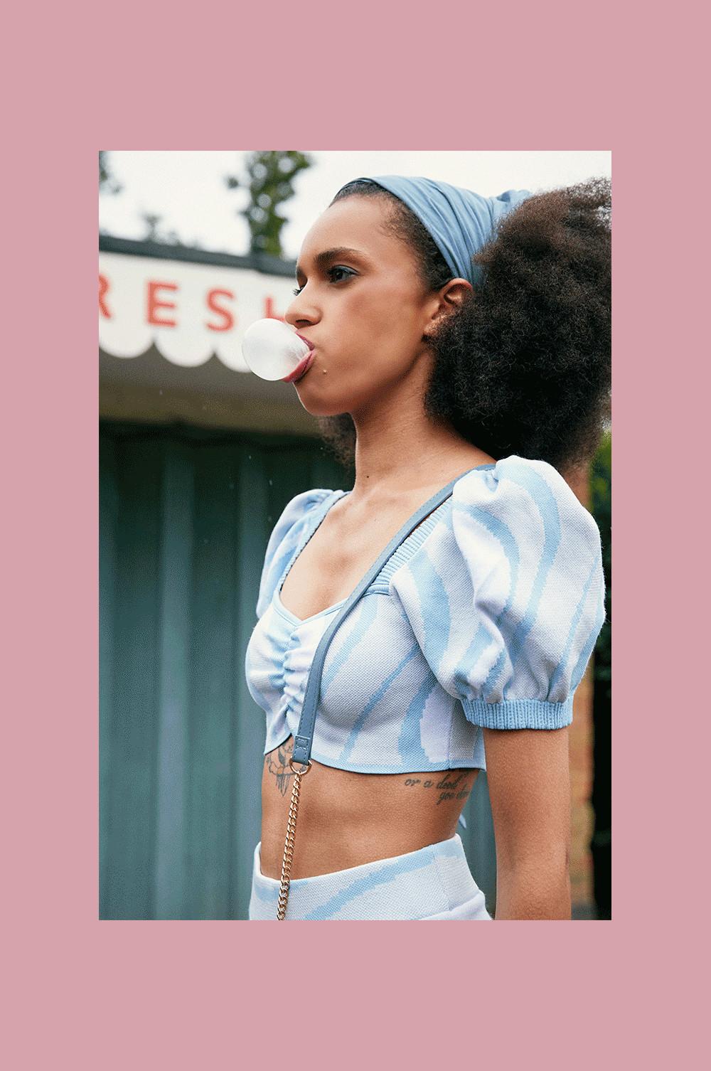 Model wearing blue swirl top